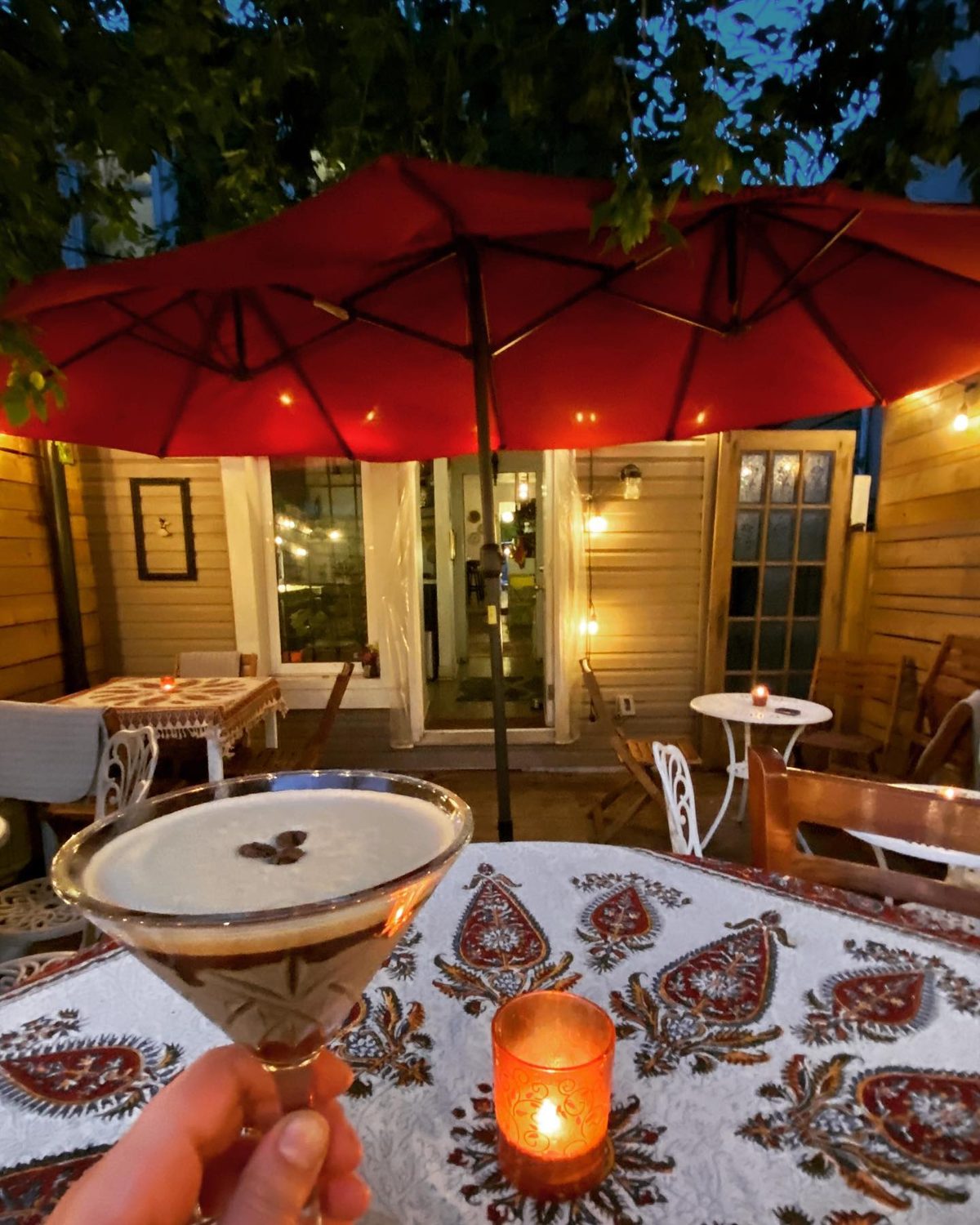 Espresso martini on the patio under the red umbrellas
